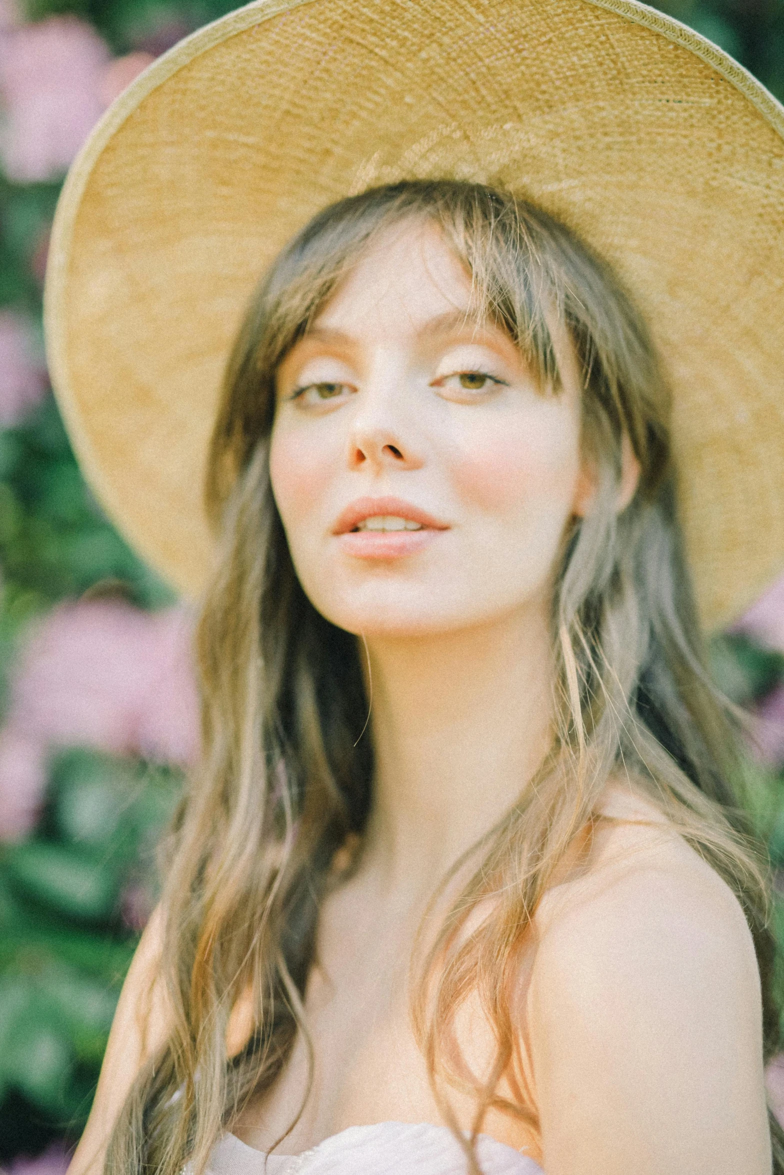 a girl wearing a hat looking into the distance