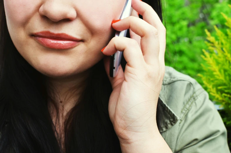 a close up of a person talking on a cell phone