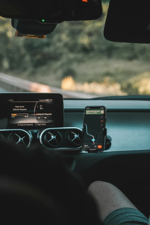 a cell phone next to head unit in car