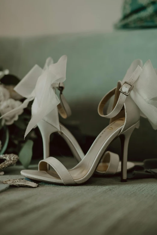 wedding shoes, flower and tiar on the bed