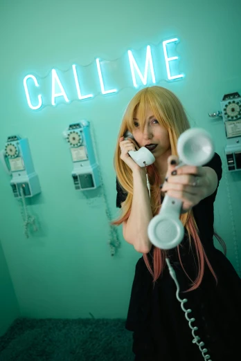 a woman holding a cell phone up to her ear while talking on a cellphone