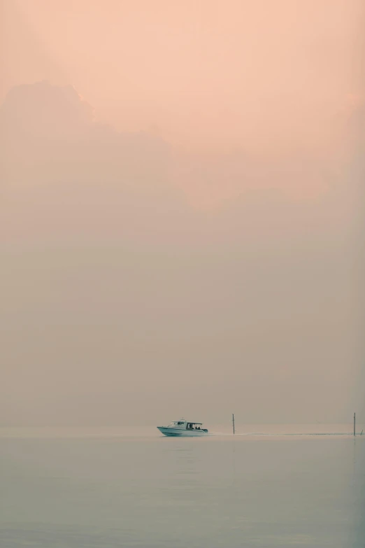 the boat is floating on calm water with a lone one