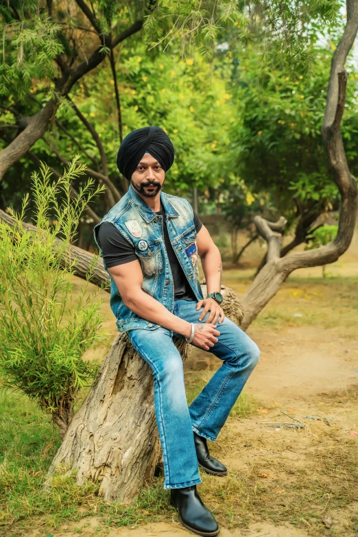 an indian man sits on a rock by himself