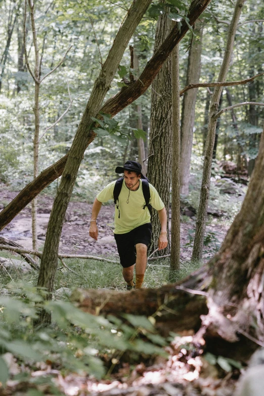 a person with a back pack on walking through a forest