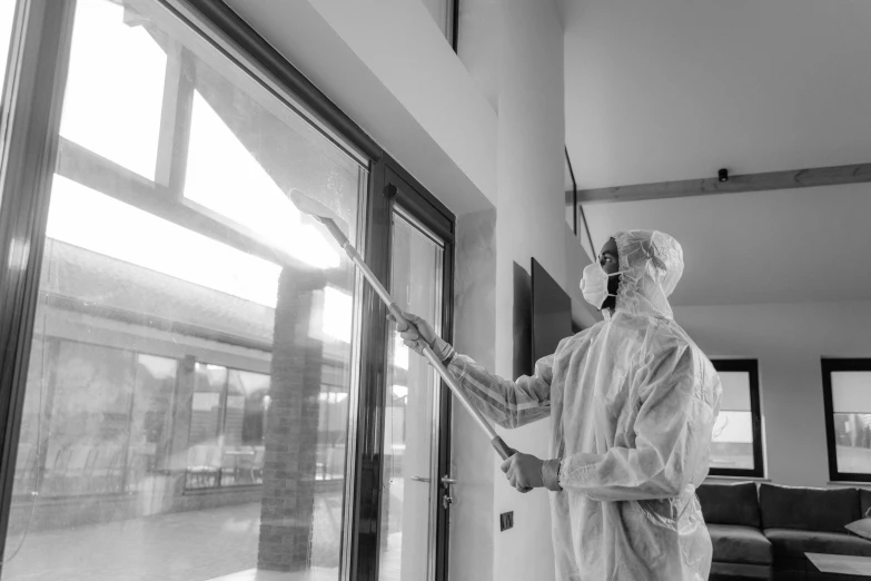 a man is painting a window in a home