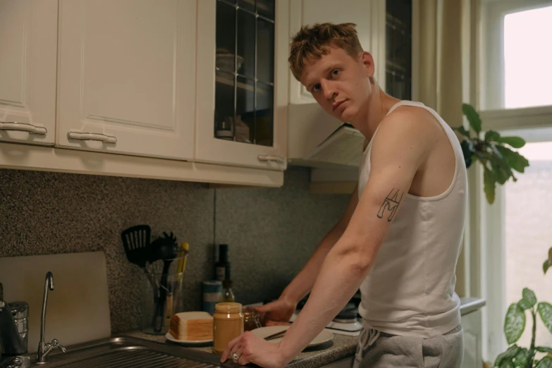 a person standing near a sink with food on it