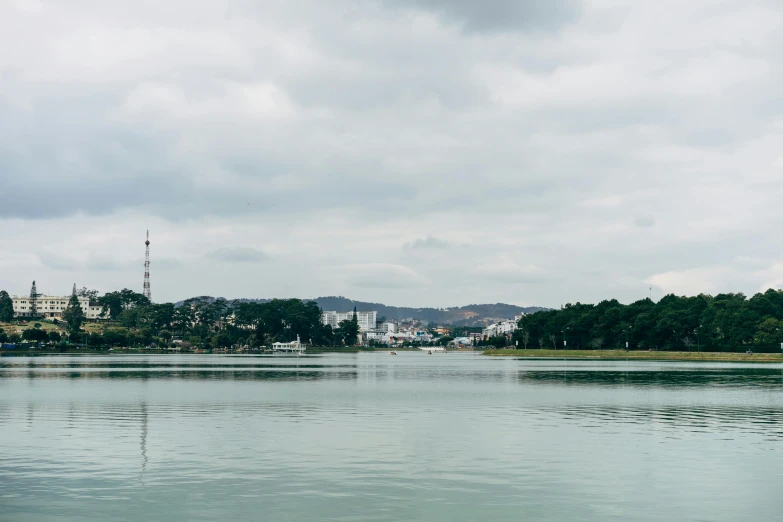 a lake filled with lots of water under a cloudy sky