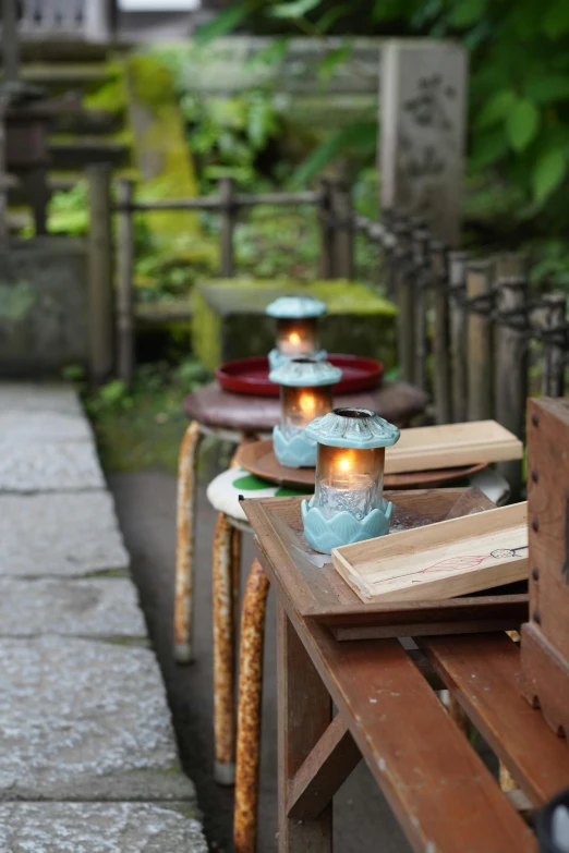 a row of wooden benches with glass candles