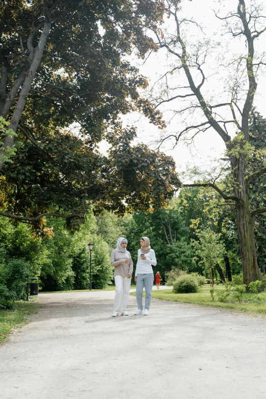 a man and a woman standing on a dirt road