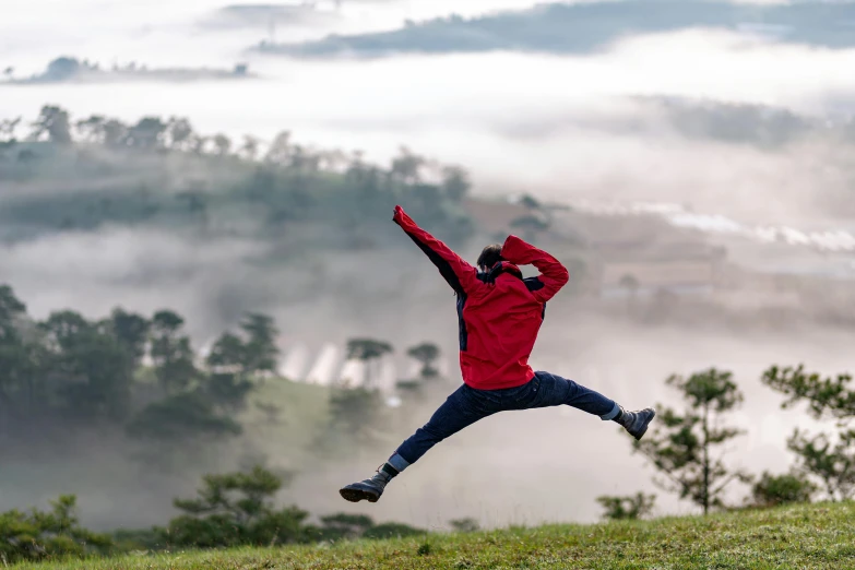 man in red jacket jumping in the air