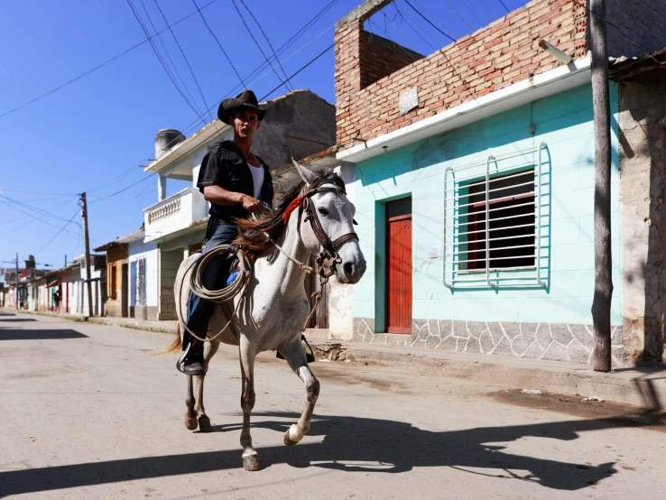 a man riding on the back of a white horse