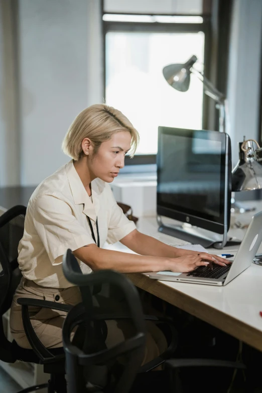 a person sitting in front of a laptop computer