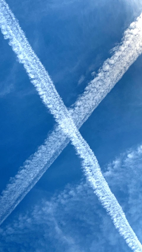 an overhead s of some blue skies with contrails