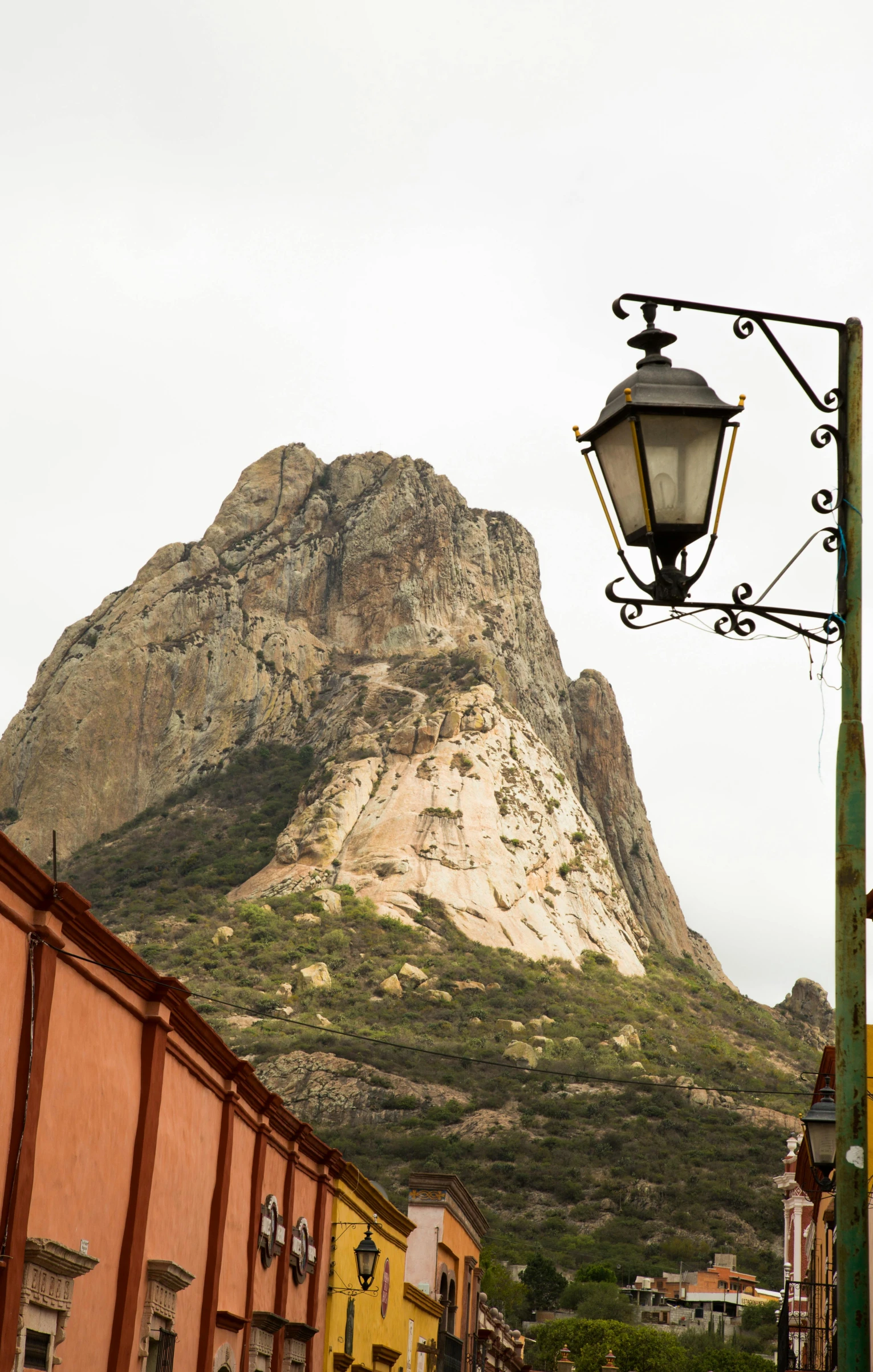 street light and some buildings with mountains in background