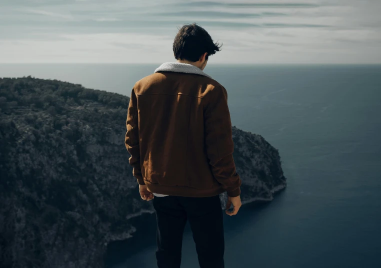 a man looking out over a body of water