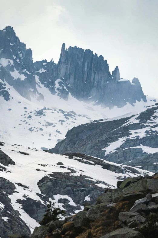 a view of mountains and snow in the middle of the day