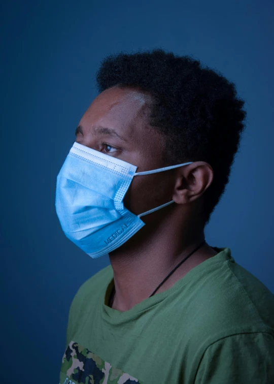 a black man with an afro hairs wearing a face mask