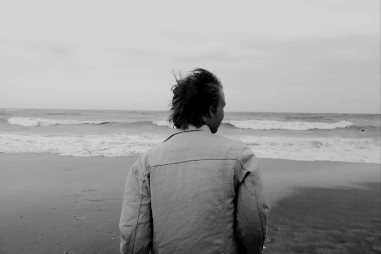 a man is watching the waves from the beach