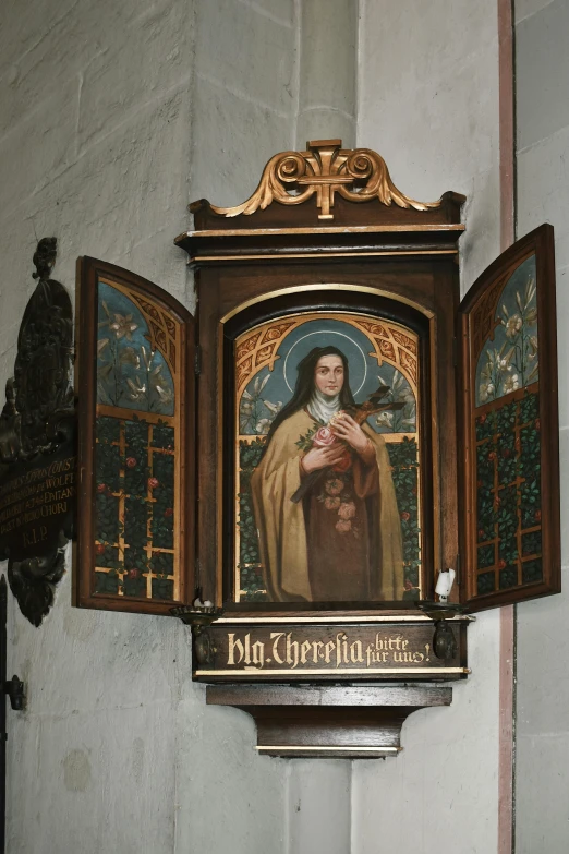 an ornate wall hanging with a painting above it