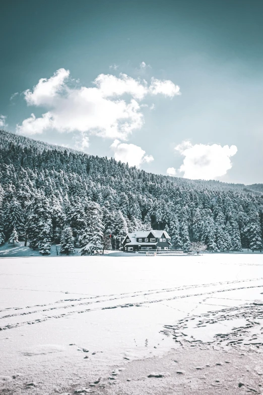 two people walk across the snow toward a mountain