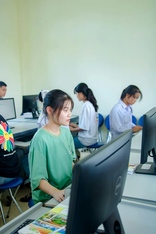 a group of students are on their computers