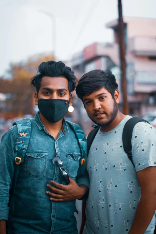 two men with face coverings and camera bags