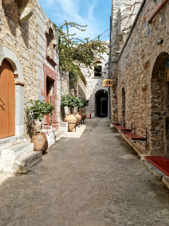 an alley way with lots of stone buildings on either side