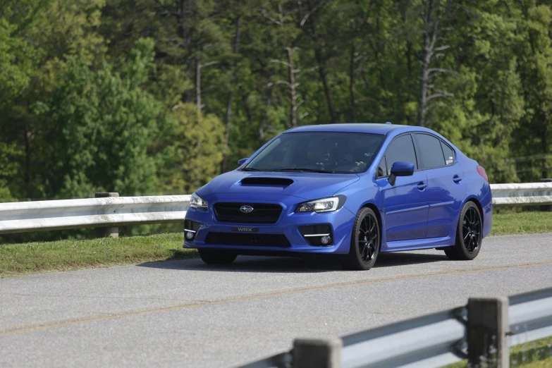 the subaru wrx is driving down the road
