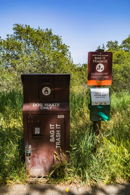 a couple of metal boxes sitting in the grass