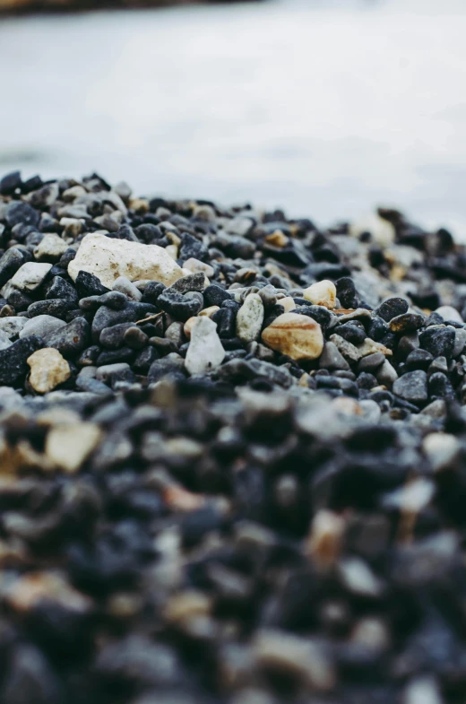 rocks, gravel, and pebbles are all sitting on the beach