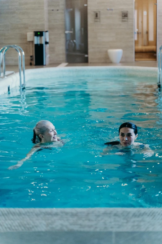 two s enjoying swimming in the pool