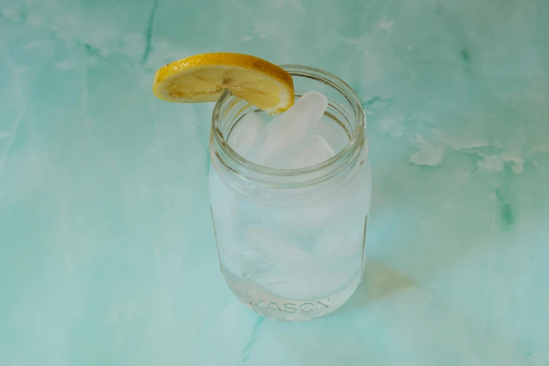 a half - eaten lemon sits in a mason jar