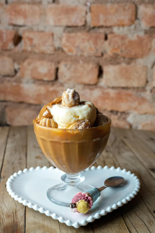 a spoon sitting in front of a cup with ice cream