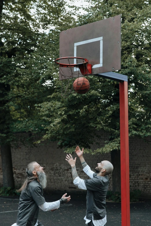 two men playing basketball on a basketball court