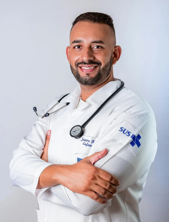 a man in a doctors coat with his arms crossed and a stethoscope around his neck