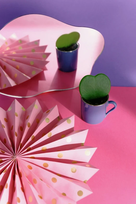 a picture of pink table setting with umbrella, coffee cup and other items