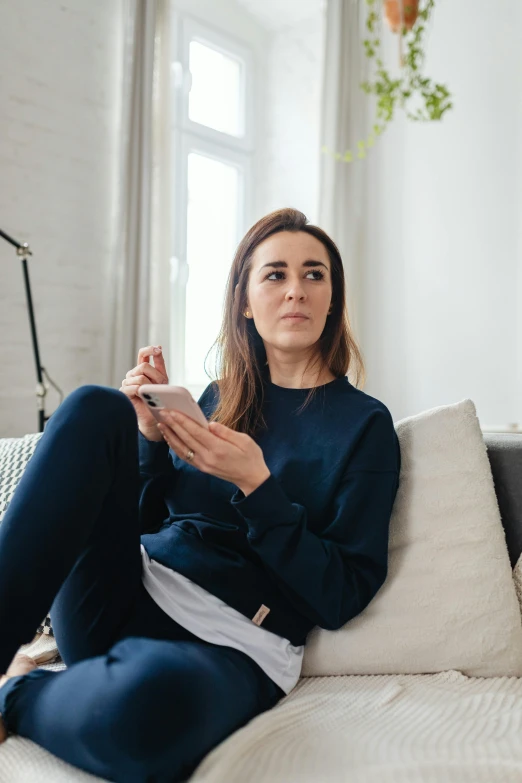 an image of a woman sitting on the couch