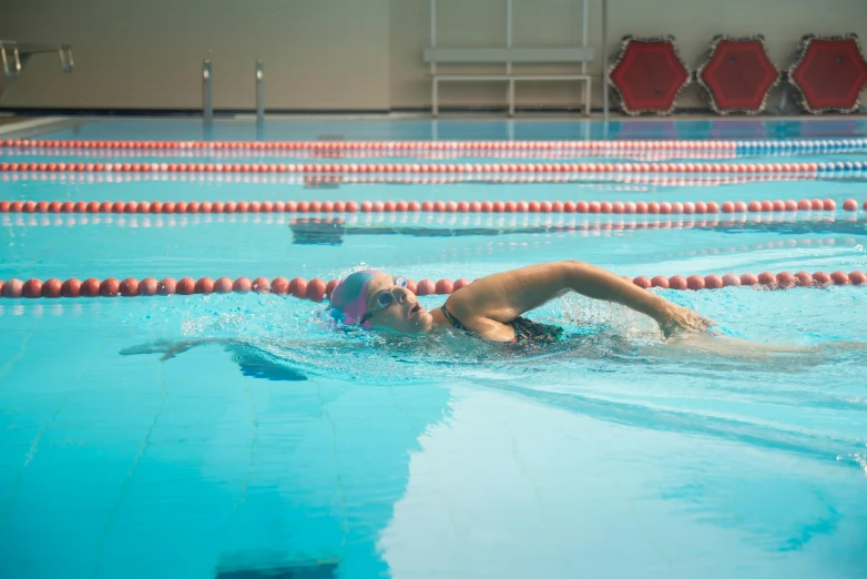 the swimmers are in the swimming pool with no one around