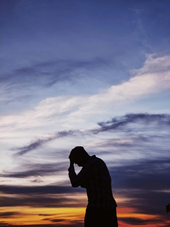 a man standing next to a street light