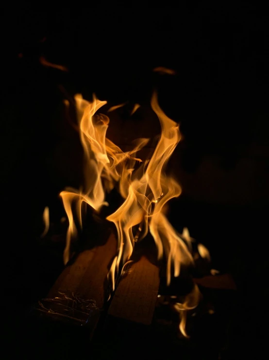 the flames that are glowing over some wood