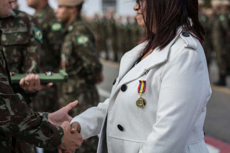 a group of soldiers standing around each other with men in uniform