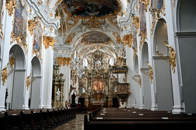 ornate decorated white and gold cathedral with large vaulted ceilings