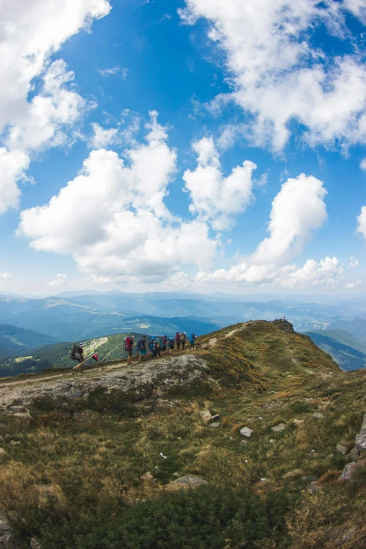 a group of people hiking up the side of a mountain