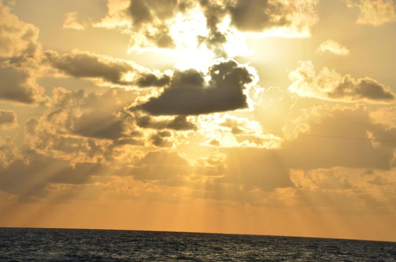 clouds over the ocean in an orange sky