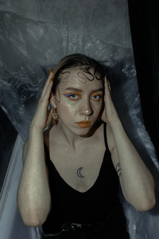 a person is wearing gold and white makeup