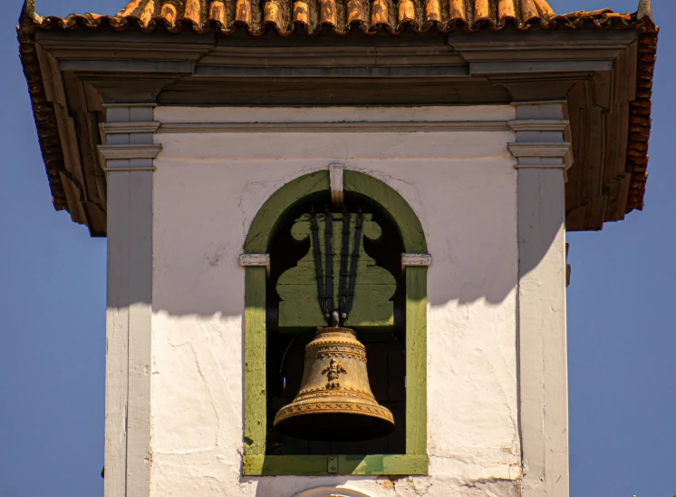 a bell tower with a clock in the background