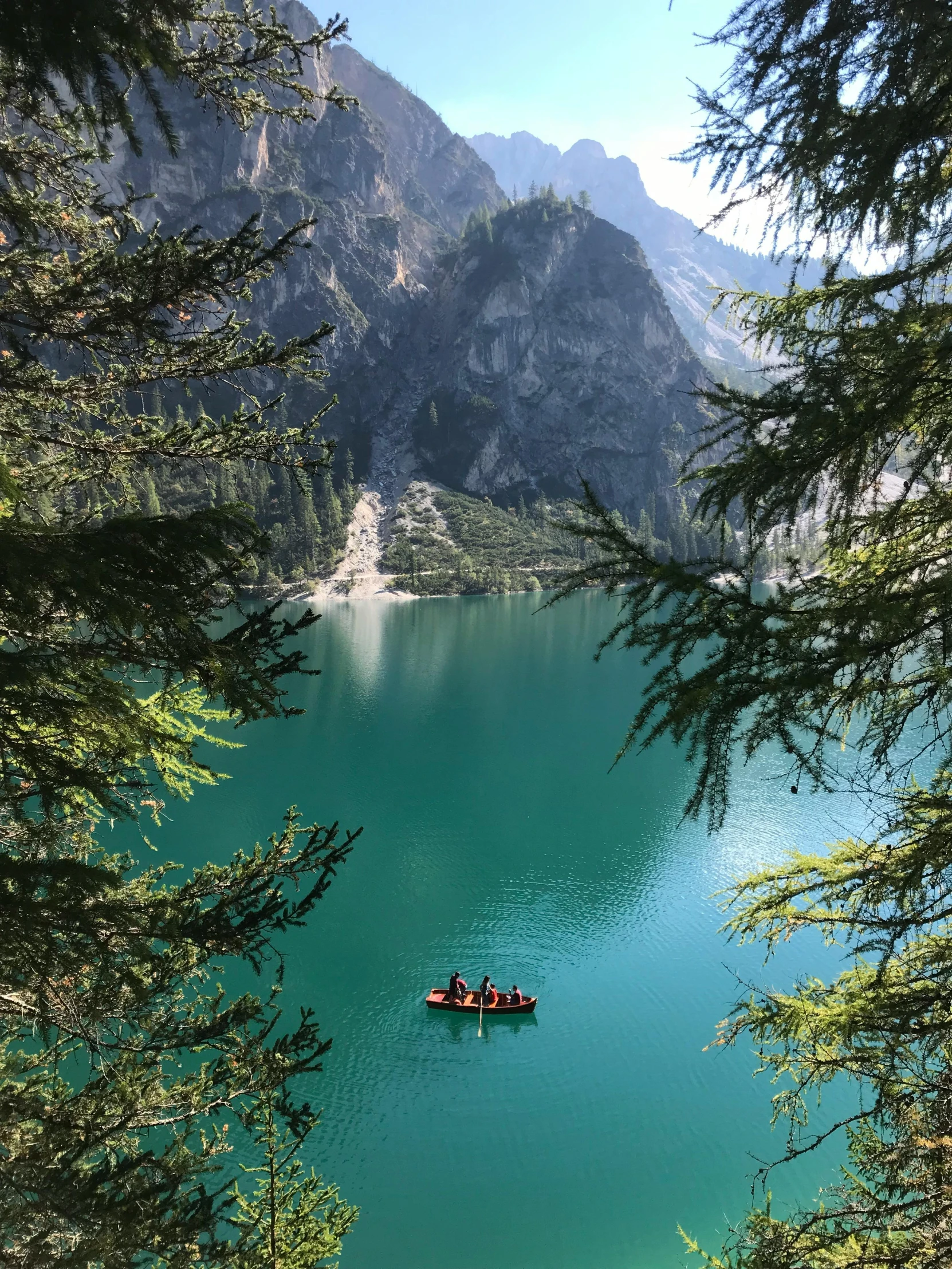 two people riding in a boat on the turquoise water