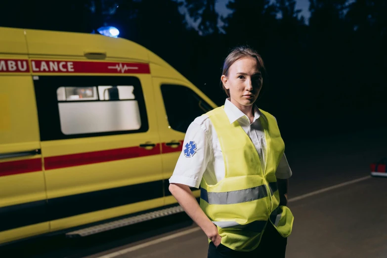 a man standing next to a parked ambulance