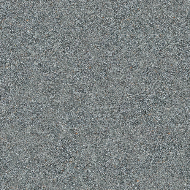 a grey surface with small dots in it