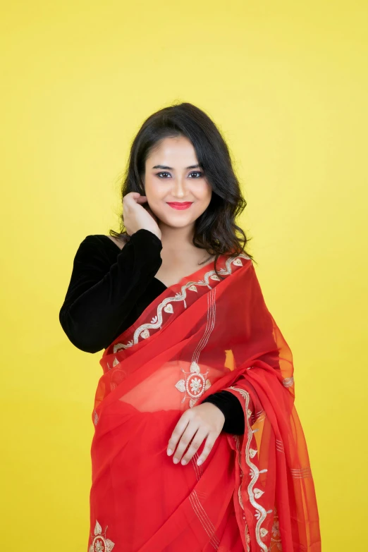 the girl is posing in an indian style dress